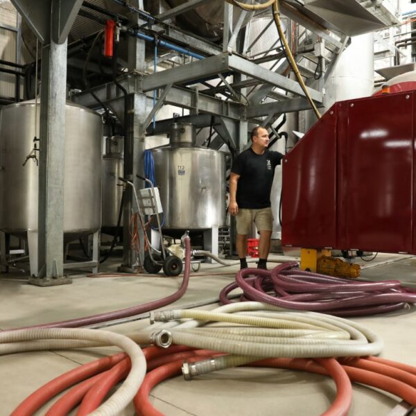 Hunter Valley winemaker Mike De Iuliis running his press in his onsite winery