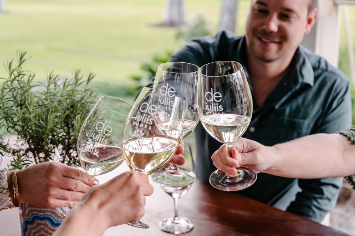 Cellar door guests at the De Iuliis Hunter Valley winery celebrate with a glass of premium wine