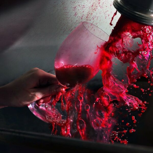Red wine filling a wine glass straight out of the winery press